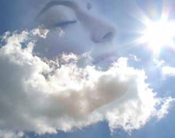 superimposed image of both blue sky and white clouds with woman's smiling face
